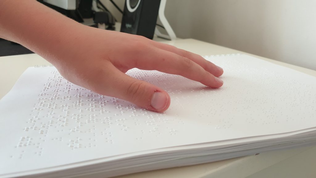 Image of child learning braille